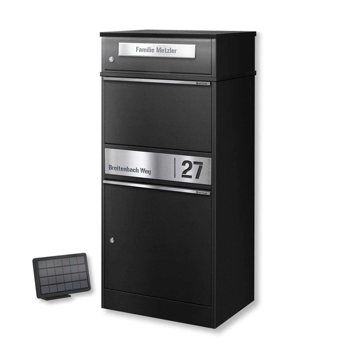 Tall black multi-compartment mailbox unit with metal address plaque reading 'Breitenbach Weg 27' and a small solar panel on the ground beside it