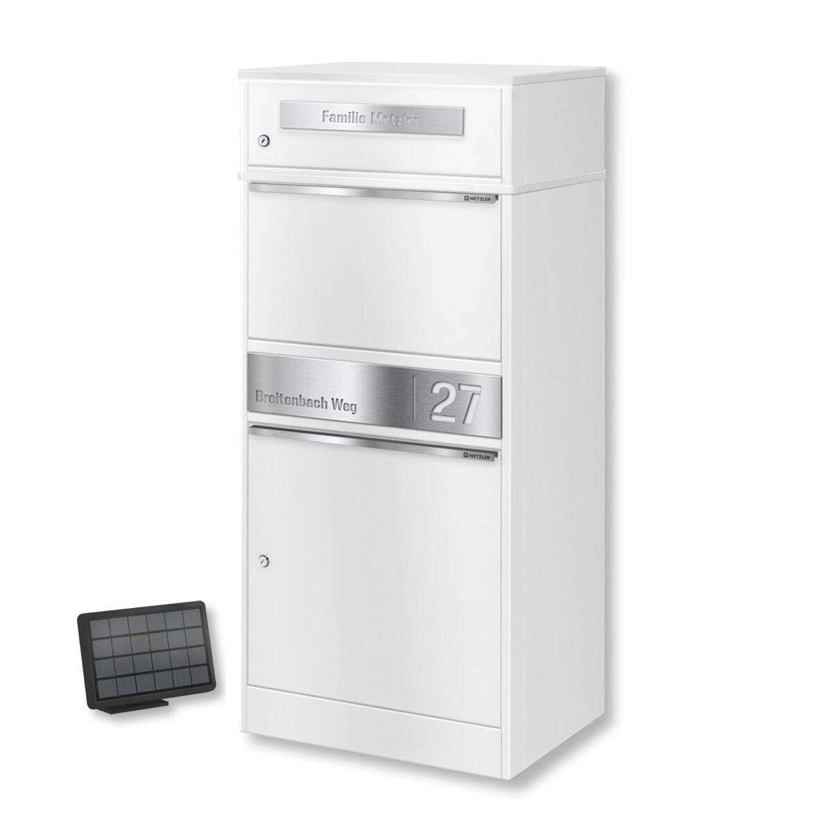 White multi‑compartment mailbox with a chrome address plate reading 'Breitenbach Weg 27'; a small solar panel sits on the floor to the left.