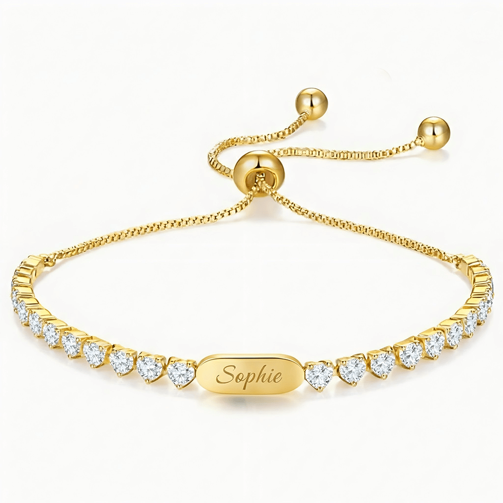 Gold bracelet with a name-plate engraving reading 'Sophie' and pavé diamond accents along the band (jewelry close-up).
